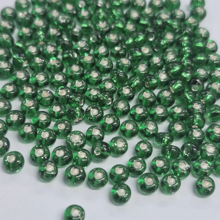 Miçanga Asmara Transparente Verde 57060  - 6/0(4,1mm) 25g Aprox. 300 Peças